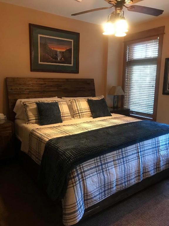 bedroom featuring ceiling fan and carpet floors