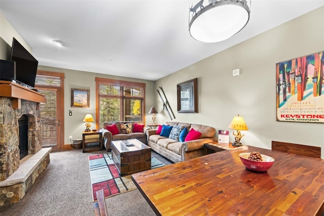 living room with carpet flooring and a fireplace