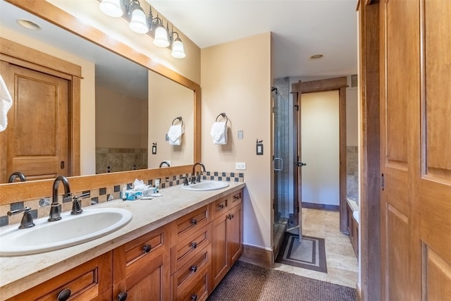 bathroom with tile patterned floors, backsplash, vanity, and walk in shower