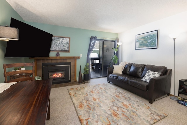 living room featuring a textured ceiling, light colored carpet, and a tiled fireplace