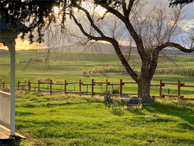 view of community with a yard and a rural view