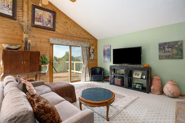 living room featuring carpet floors, high vaulted ceiling, and wood walls