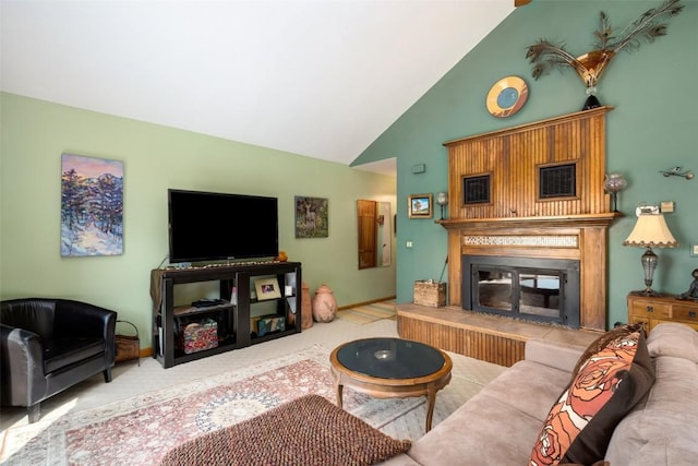 carpeted living room with high vaulted ceiling