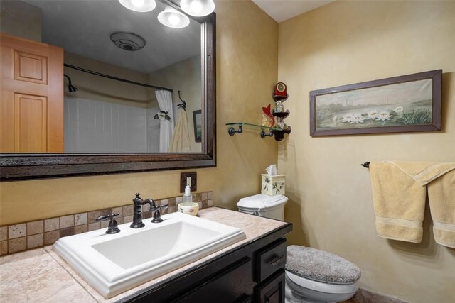 bathroom with vanity, toilet, and a shower with shower curtain