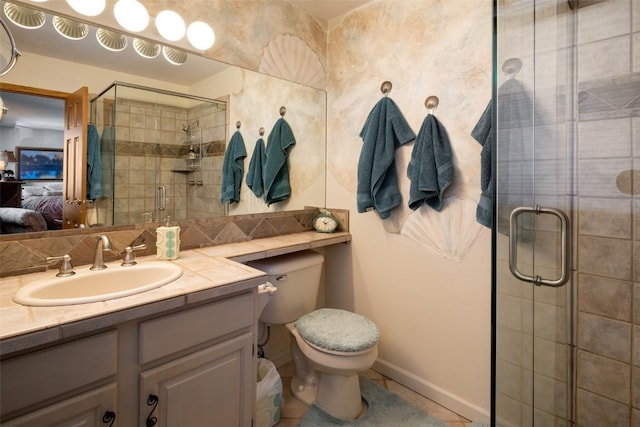 bathroom with vanity, toilet, and a shower with door