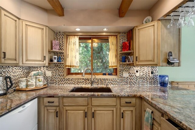 kitchen featuring white dishwasher, sink, beam ceiling, and backsplash