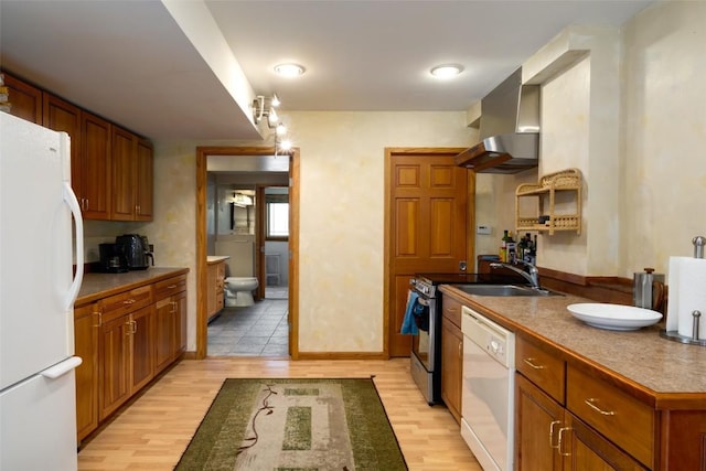 kitchen with white appliances, sink, light hardwood / wood-style flooring, and exhaust hood