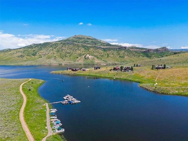 birds eye view of property with a water and mountain view