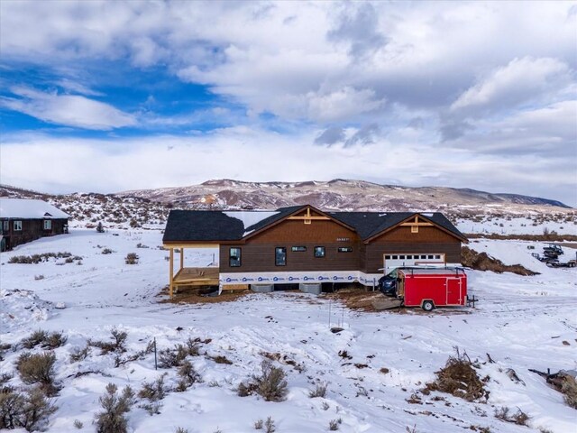 unfinished property featuring a garage and a mountain view