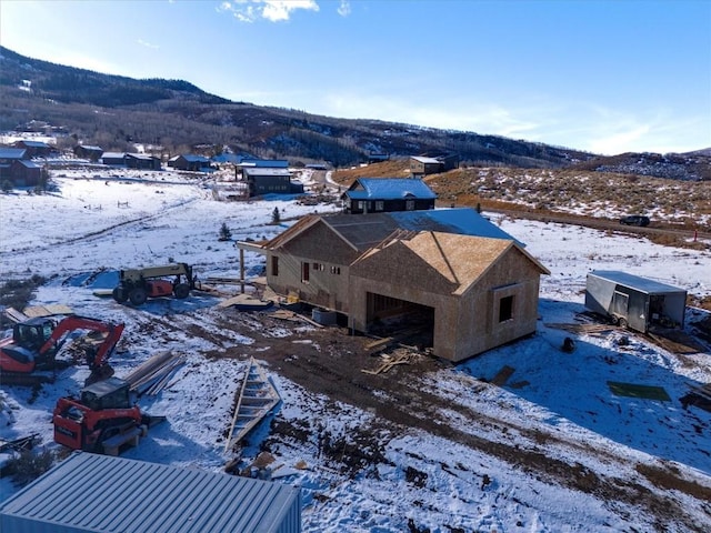 snowy aerial view with a mountain view