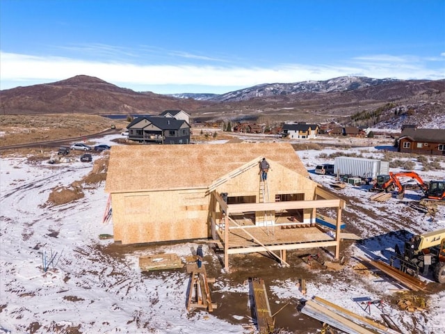 snowy aerial view featuring a mountain view