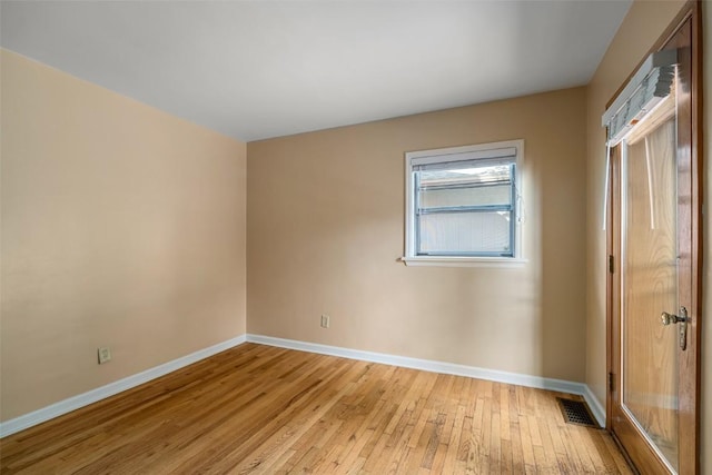 unfurnished room with light hardwood / wood-style floors