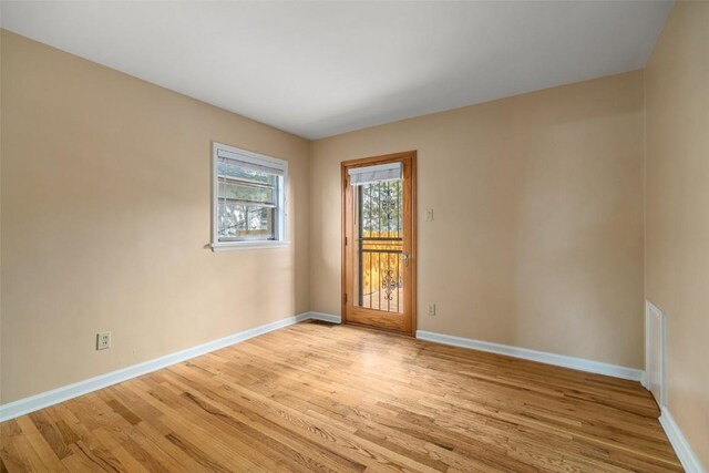 spare room featuring light hardwood / wood-style flooring