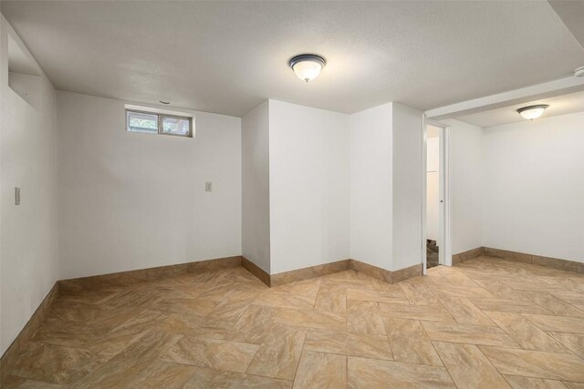 basement featuring a textured ceiling