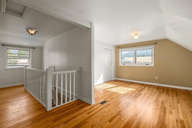 bonus room featuring light hardwood / wood-style floors and lofted ceiling