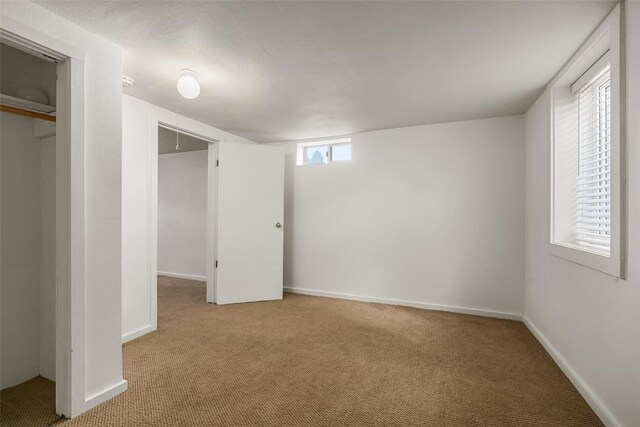 unfurnished bedroom featuring light colored carpet and a closet