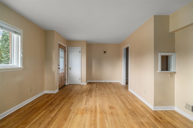 spare room featuring light hardwood / wood-style flooring