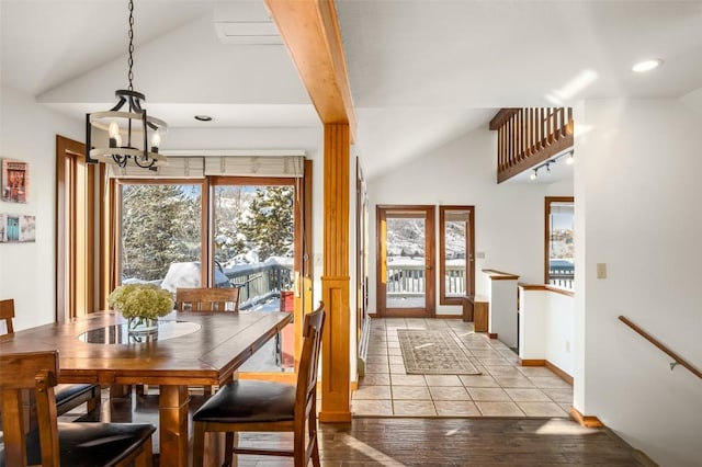 dining area featuring vaulted ceiling, an inviting chandelier, and light wood-type flooring