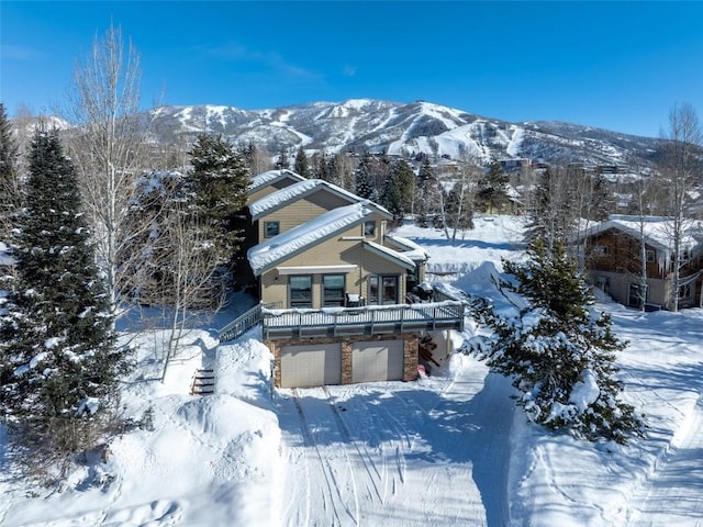 snowy aerial view with a mountain view