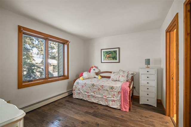 bedroom with a baseboard radiator and dark hardwood / wood-style floors