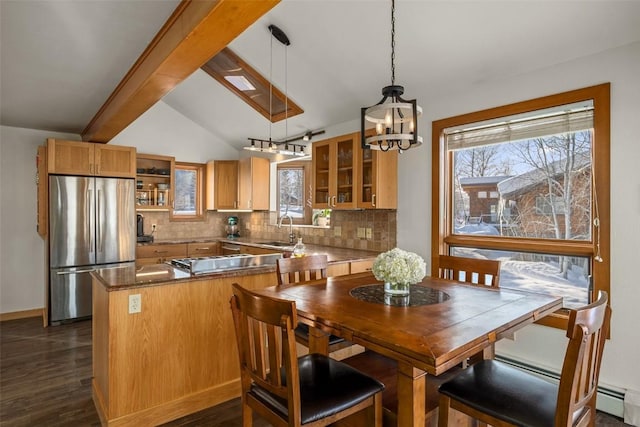 dining room featuring a baseboard radiator, dark hardwood / wood-style flooring, sink, and vaulted ceiling with beams