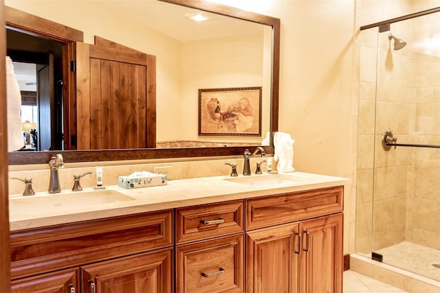 bathroom with tile patterned flooring, vanity, and walk in shower