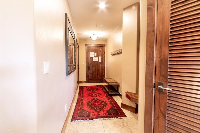 doorway to outside with light tile patterned floors