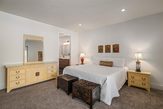 bedroom featuring dark carpet and connected bathroom