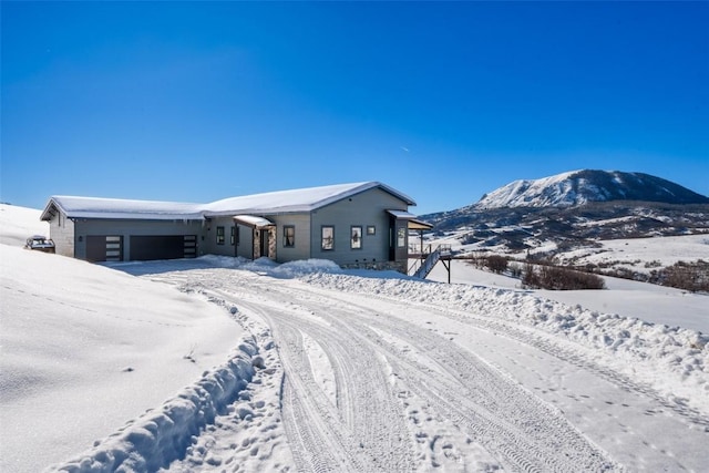 view of front of home featuring a garage and a mountain view