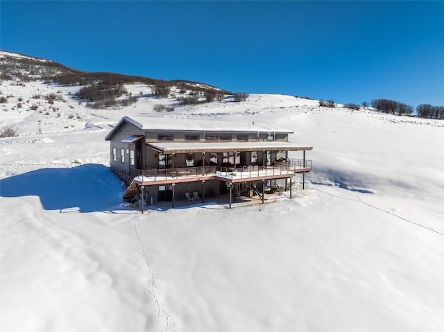 snow covered property featuring a mountain view