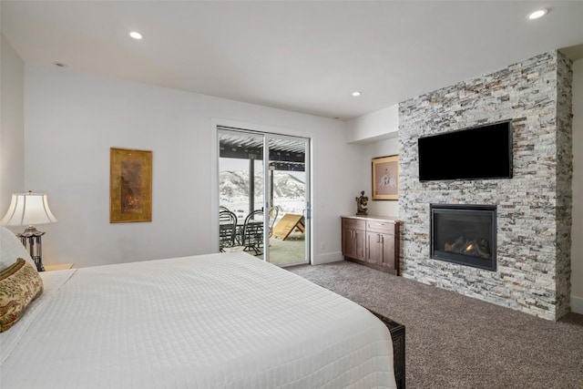 bedroom featuring light carpet, recessed lighting, a fireplace, and access to exterior