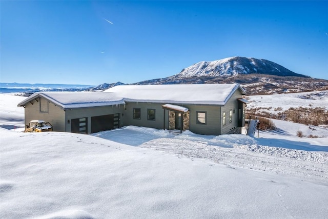 view of front of house with a garage and a mountain view