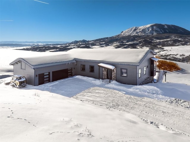 view of front of home featuring a garage and a mountain view