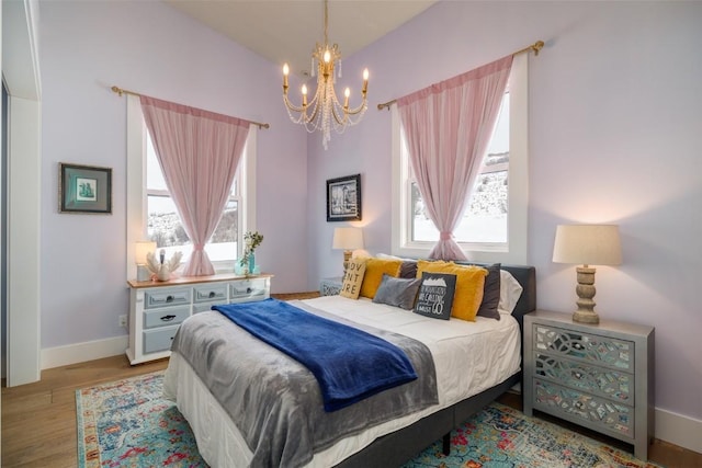 bedroom featuring light hardwood / wood-style flooring and a notable chandelier