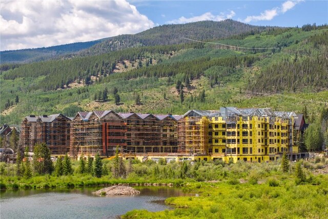 birds eye view of property with a water and mountain view