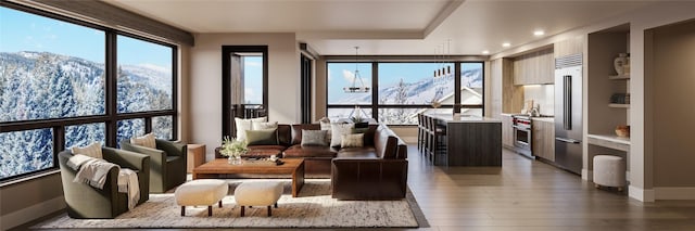 sunroom with a wealth of natural light and a mountain view