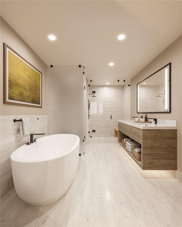 bathroom featuring vanity, separate shower and tub, and tile walls