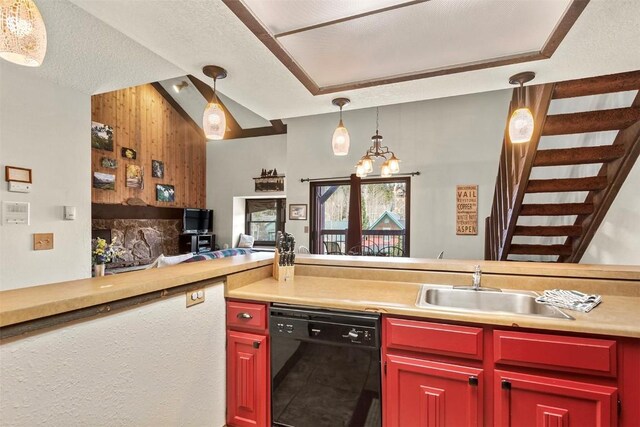 kitchen featuring a textured ceiling, sink, decorative light fixtures, a chandelier, and black dishwasher