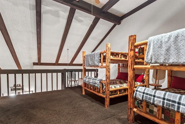 carpeted bedroom with lofted ceiling with beams