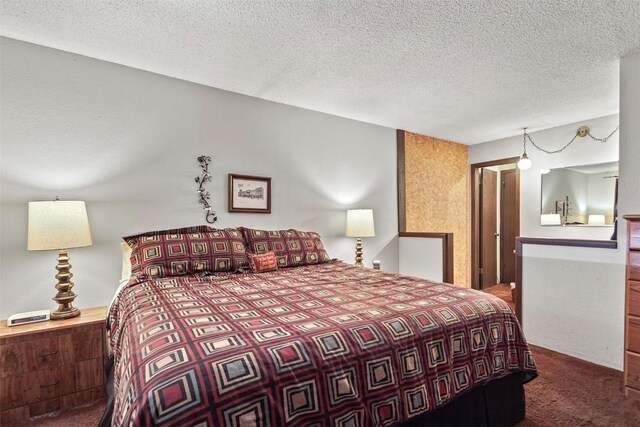 carpeted bedroom with a textured ceiling