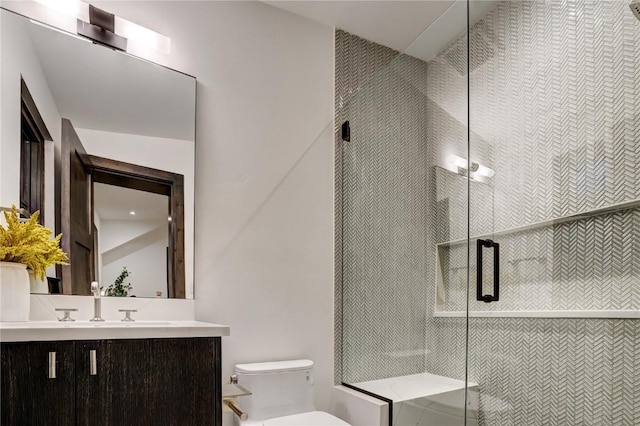 bathroom with vanity, an enclosed shower, and toilet