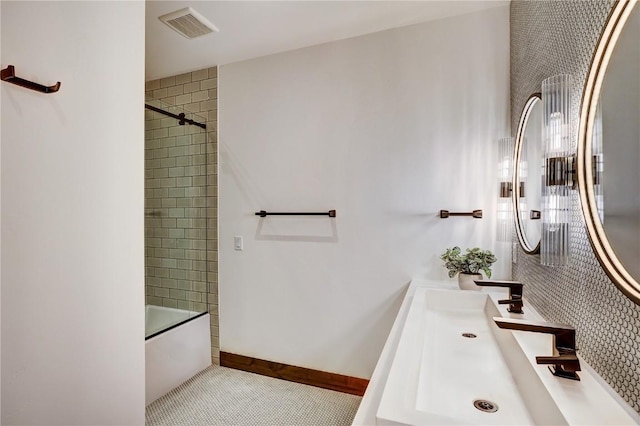 bathroom with tile patterned floors, vanity, and combined bath / shower with glass door