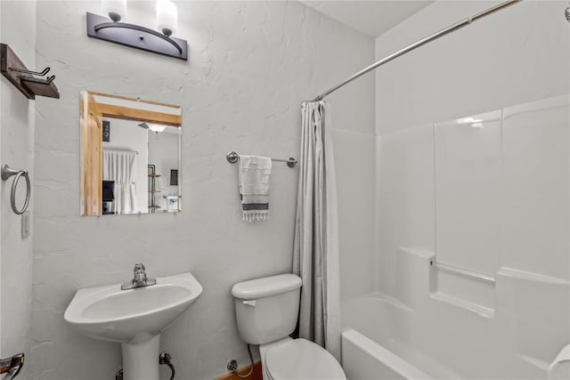 full bathroom with toilet, shower / bath combo with shower curtain, and sink