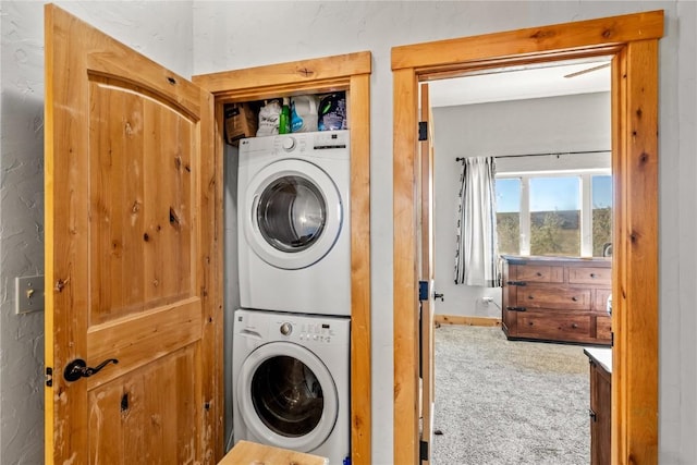 laundry area featuring carpet flooring and stacked washer and dryer