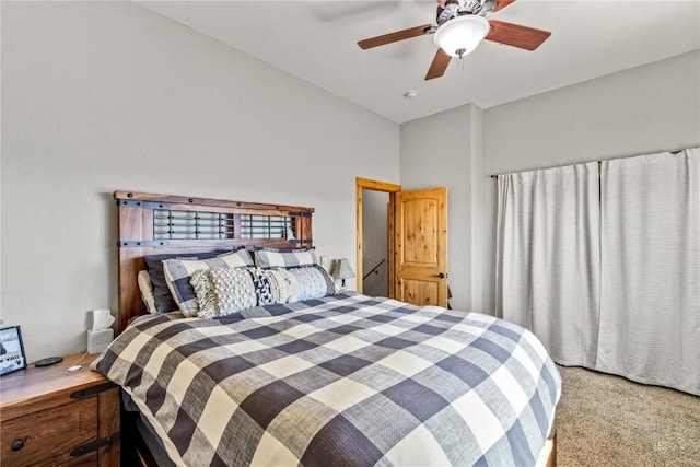 carpeted bedroom featuring ceiling fan and lofted ceiling