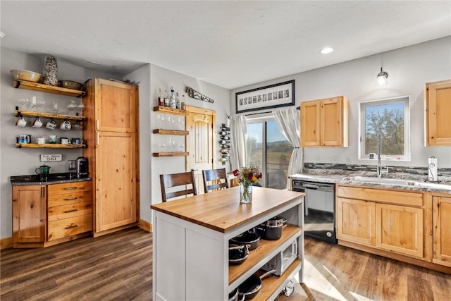 kitchen with light brown cabinetry, dishwasher, wood-type flooring, and sink