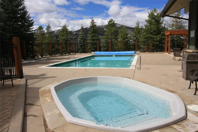 view of swimming pool with a pergola, an in ground hot tub, and a patio