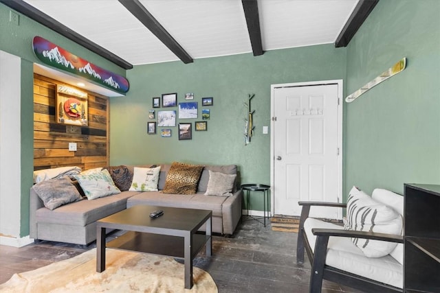 living room featuring wood walls, beam ceiling, and dark hardwood / wood-style floors