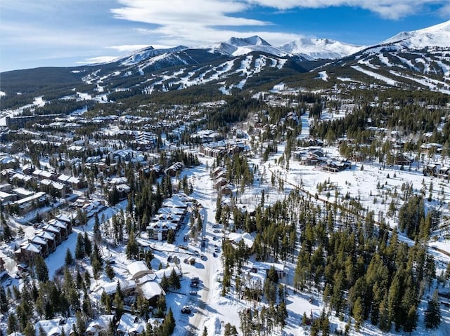 snowy aerial view with a mountain view