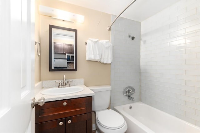 full bathroom with vanity, toilet, and tiled shower / bath